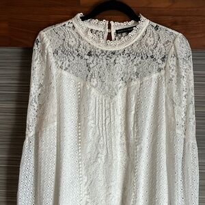 White House Black Market Mixed lace blouse with long sleeves. Color Ecru. Size 8